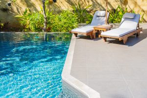 umbrella-chair-around-outdoor-swimming-pool-resort-hotel-vacation-leisure